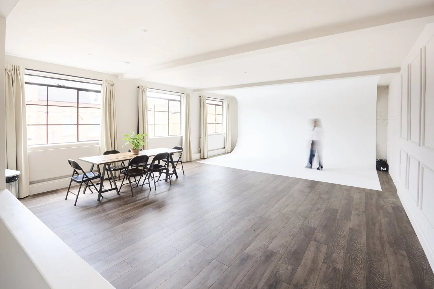 Studio 4 daylight studio with textured walls and dark wood flooring